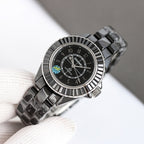 Chanel automatic wristwatch angled on glove, black dial with patterned bezel