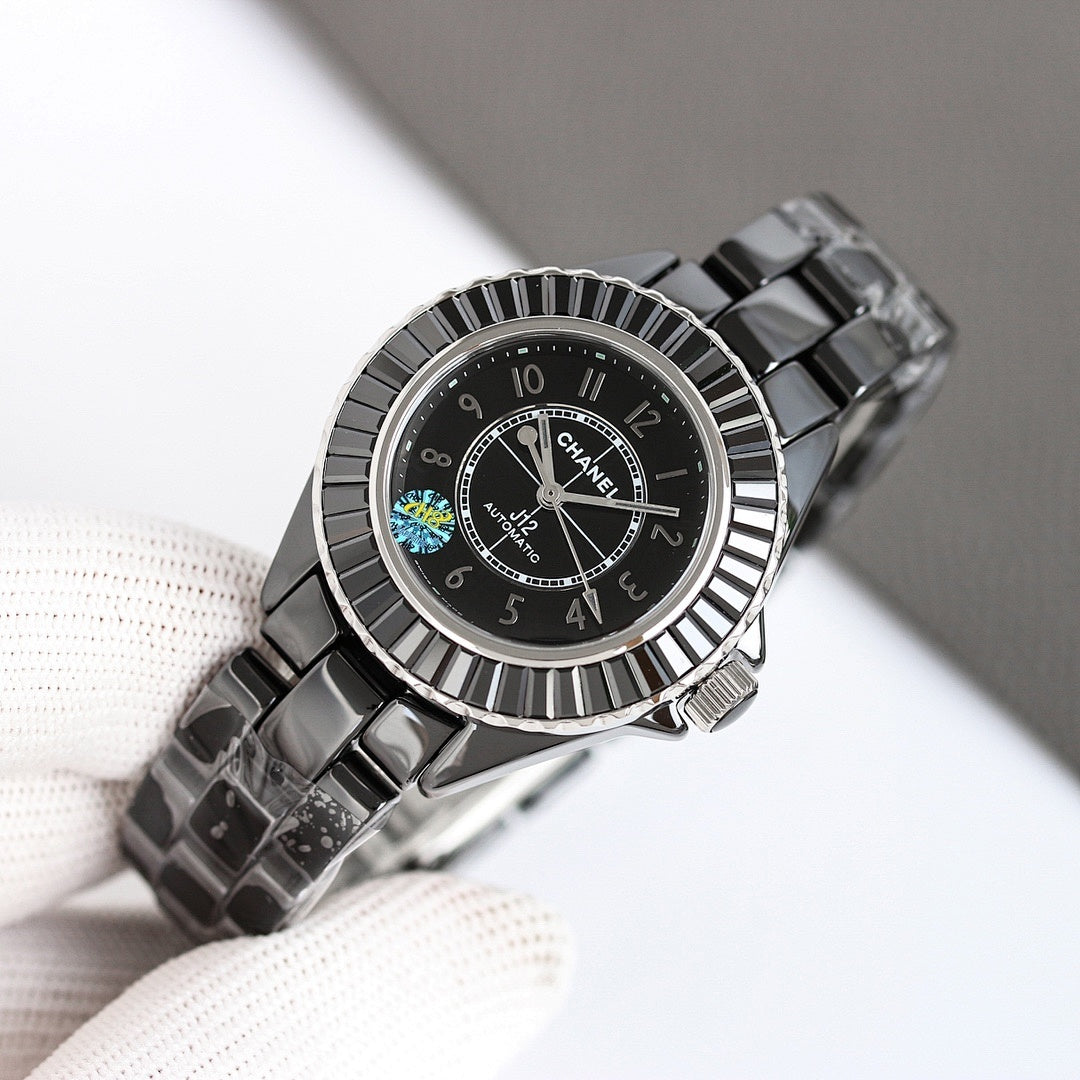 Chanel automatic wristwatch angled on glove, black dial with patterned bezel