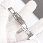 Chanel watch with white ceramic bracelet and silver-tone clasp, side profile view.