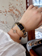 Chanel wristwatch with black dial and gold-tone linked band on a wrist