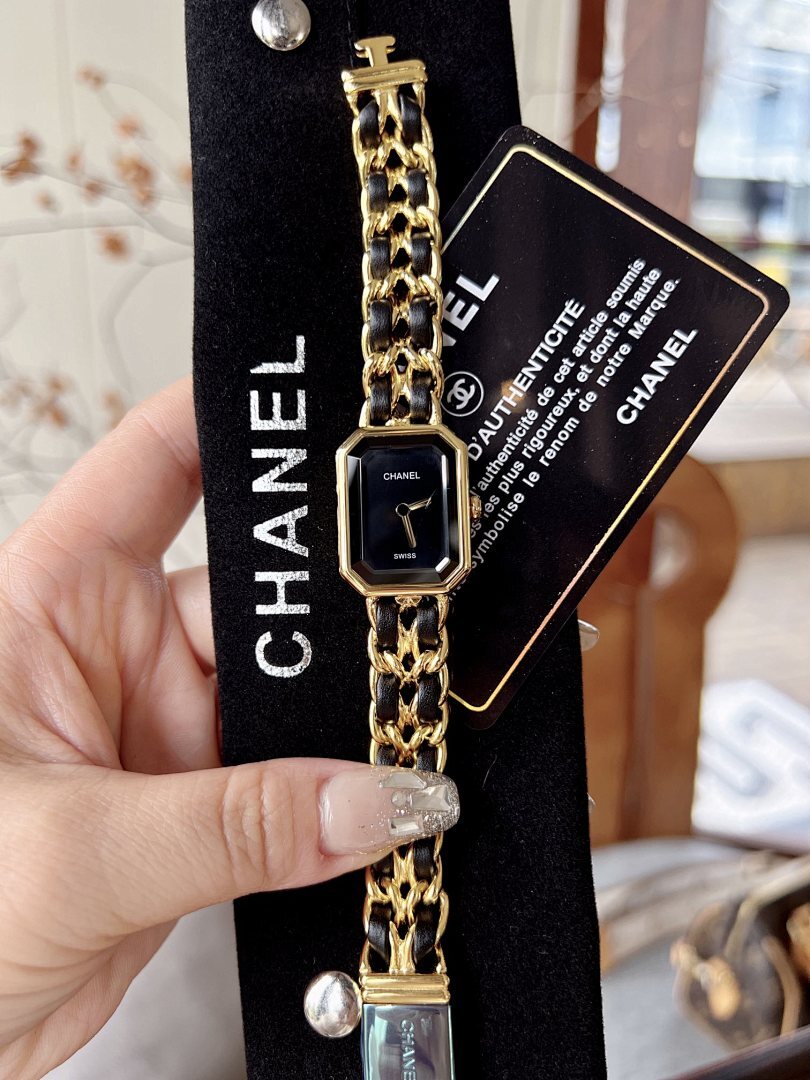 Chanel watch with black dial and gold-tone octagonal case, close-up