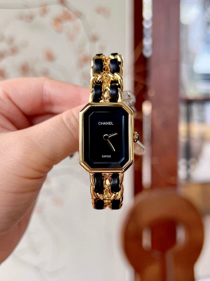 Chanel watch with black dial, gold-tone octagonal case, and linked bracelet