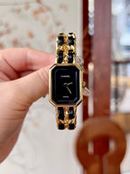 Chanel watch with black dial, gold-tone octagonal case, and linked bracelet