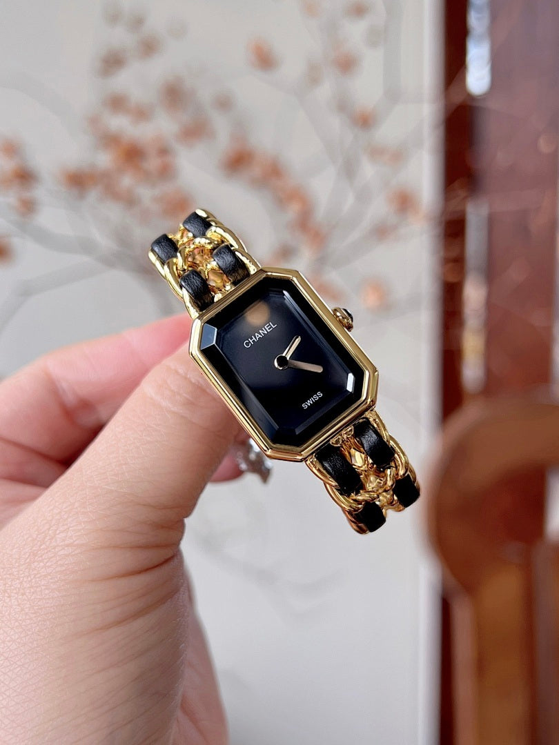 Chanel wristwatch with black dial and gold-tone octagonal case, close view