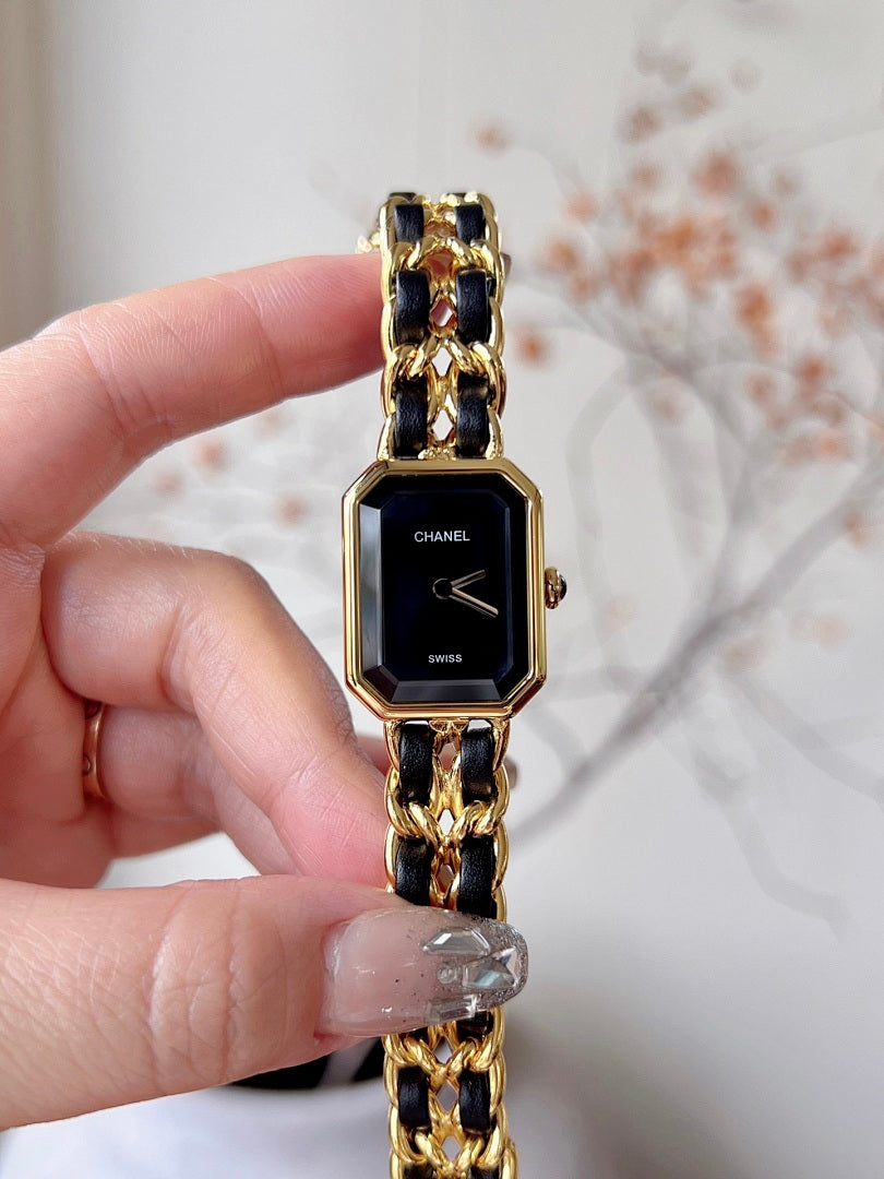 Chanel watch with black dial, gold-tone octagonal case, and linked bracelet