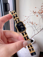 Chanel watch on gold-tone link bracelet with black square dial and gold hands