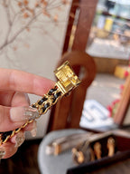 Chanel watch clasp and gold-tone link bracelet detail on a hand