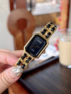 Chanel watch on gold-tone link bracelet with black dial and gold-tone details