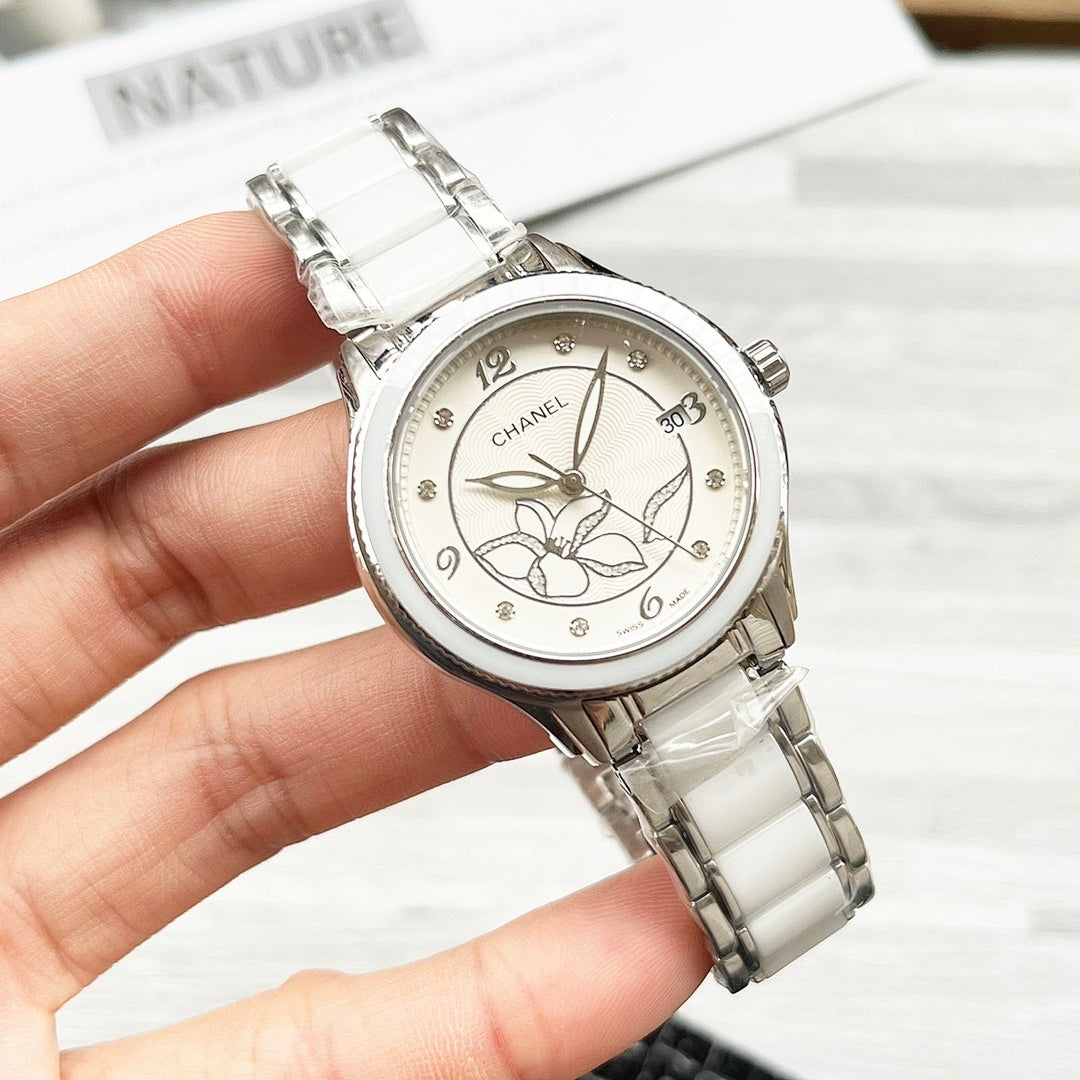 Chanel watch with white metal bracelet and silver-tone floral dial, front view