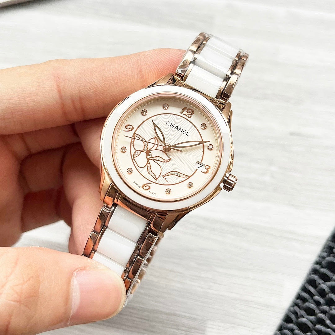 Chanel watch with rose-gold case, white metal bracelet, and floral dial close-up