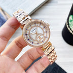 Chanel watch with crystal bezel, white dial, blue accents, two-tone metal bracelet