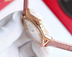 Chanel watch with blush pink leather strap, rose-gold case side with diamond-set bezel