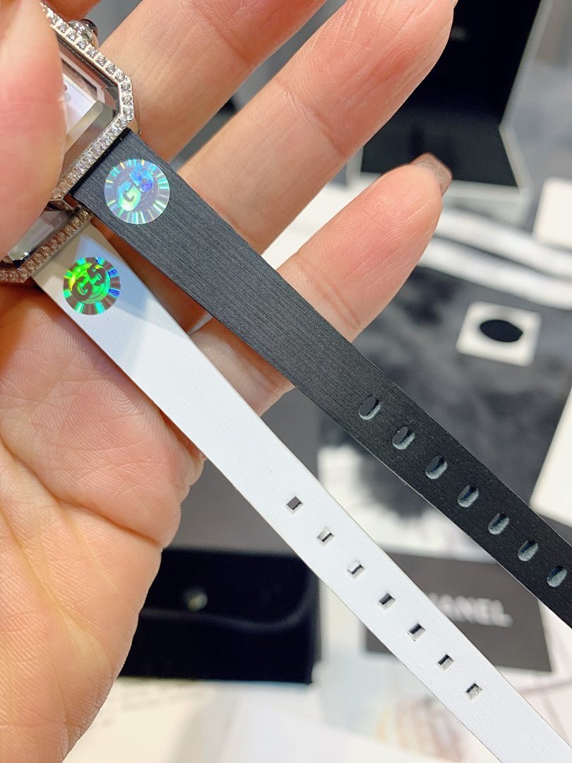 Chanel watch strap detail with gray band and white perforated strap sections