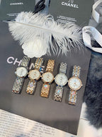 Chanel watch set on display with silver metal straps and round light dials