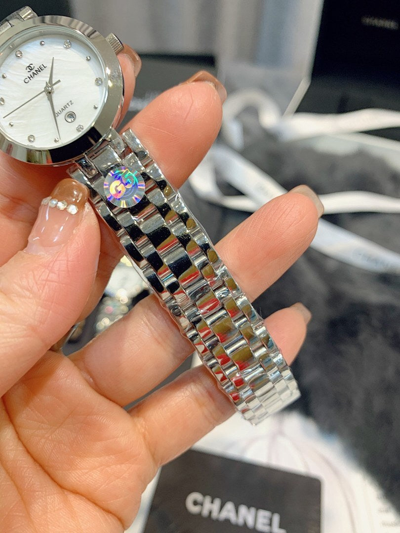 Chanel wristwatch bracelet close-up with iridescent stones and silver case