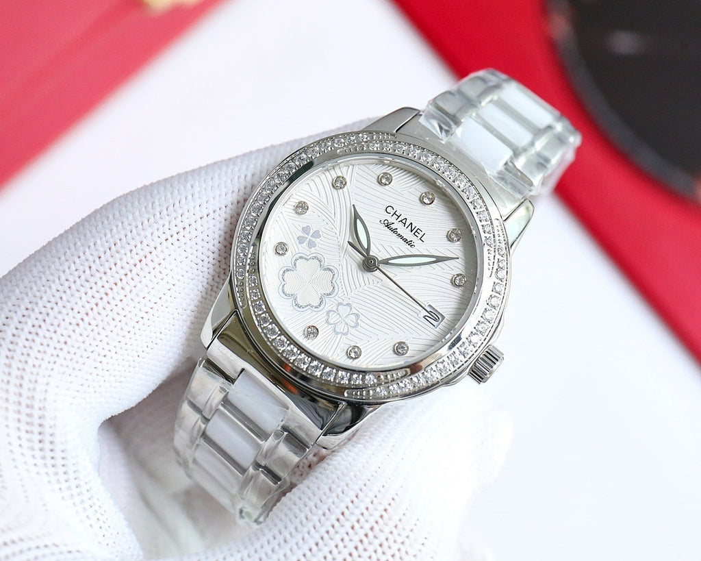 Wristwatch with silver-tone link bracelet, diamond bezel, white floral dial
