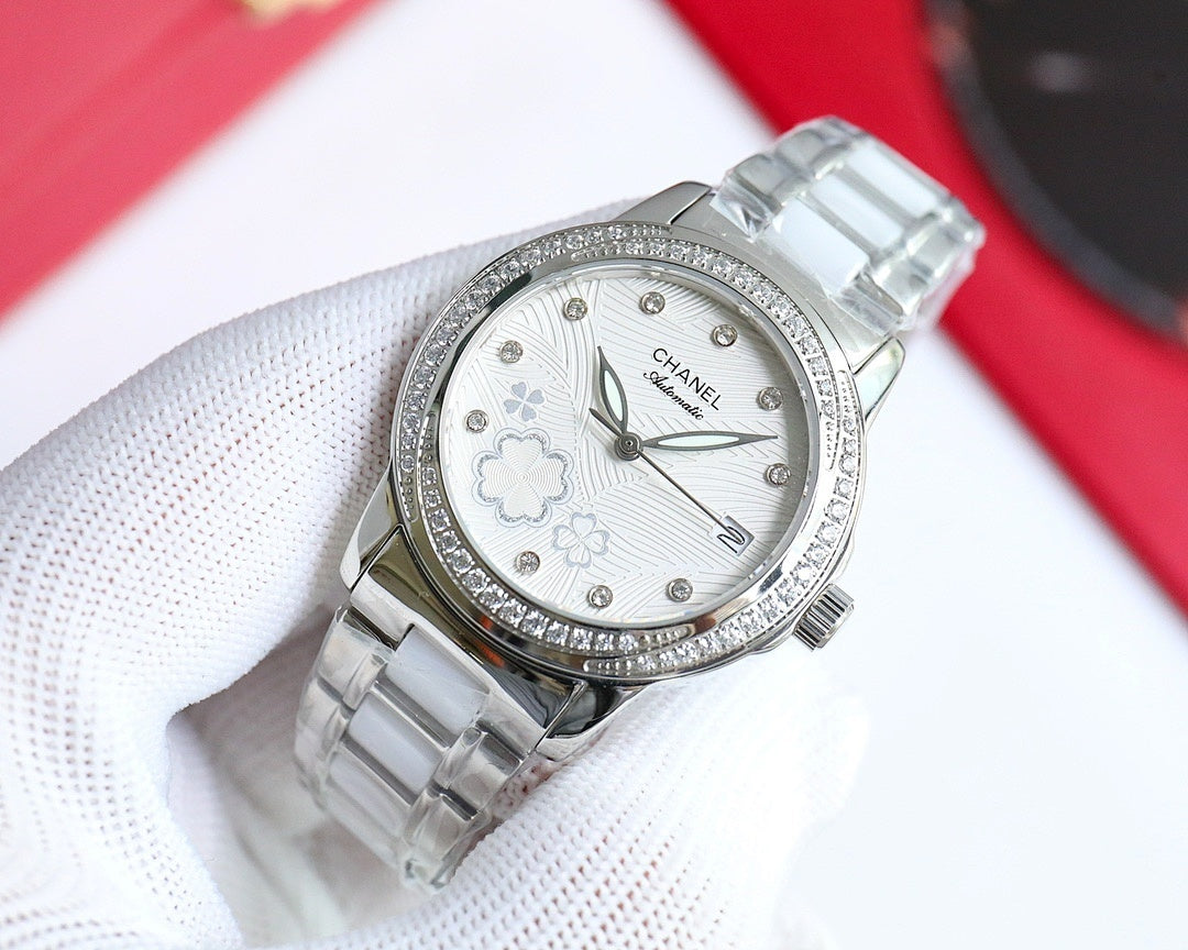 Wristwatch with silver-tone link bracelet, diamond bezel, white floral dial