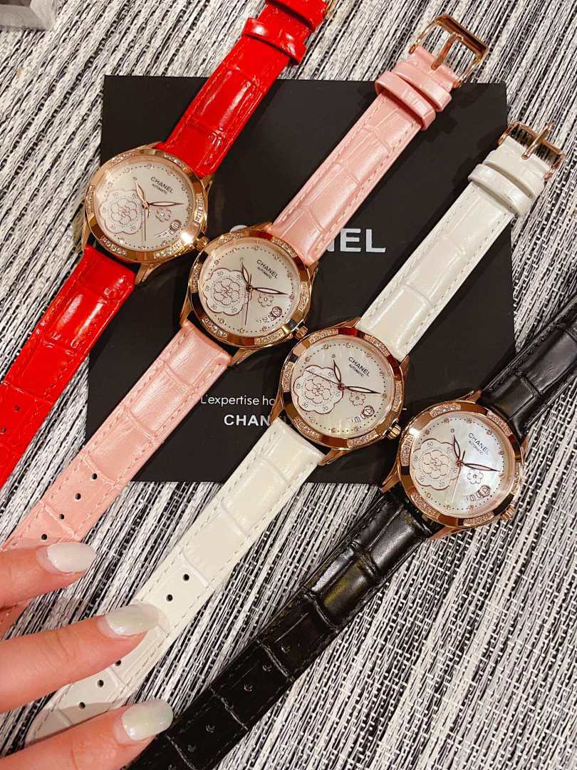 Chanel watch with red leather strap, round gold-tone case and floral dial