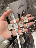 Chanel square-faced wristwatches with black, white, and brown leather straps