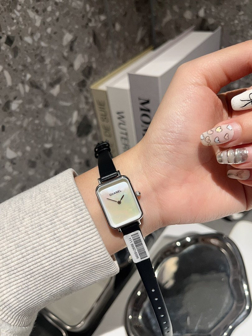 Chanel square-faced wristwatch with black leather strap and light dial