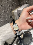 Chanel square-faced wristwatch with black leather strap and light dial