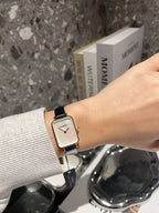 Chanel square-faced wristwatch with black leather strap and light dial