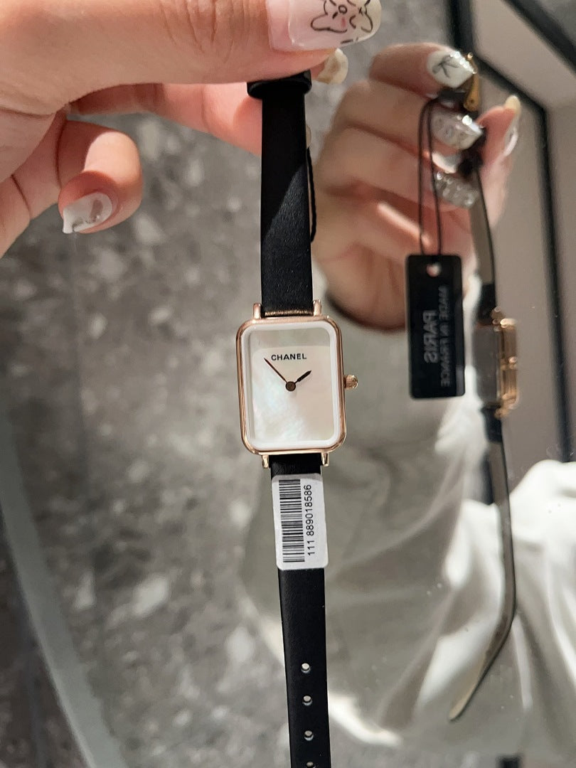Chanel square-faced wristwatch with black leather strap and light dial