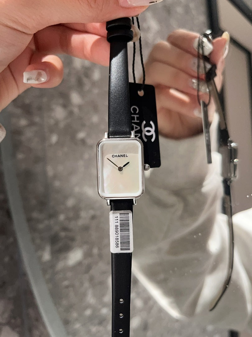 Chanel square-faced wristwatch with black leather strap and light dial