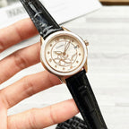 Chanel wristwatch with floral cream dial and black leather strap.
