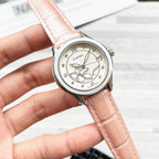 Chanel wristwatch with floral cream dial and light pink leather strap.