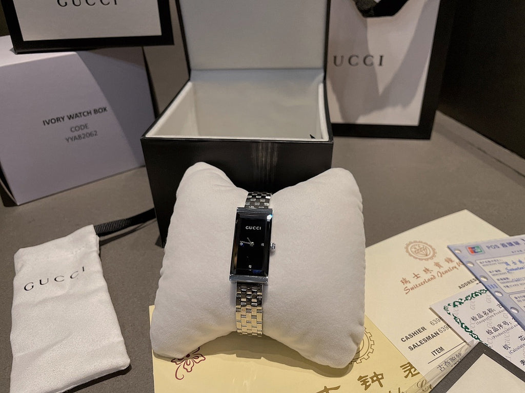 Chanel wristwatch in open box with silver bracelet and black dial
