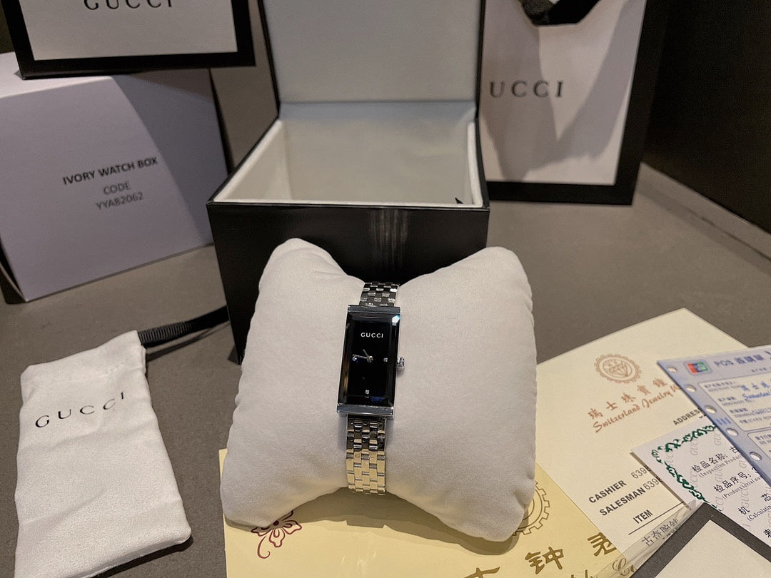 Chanel wristwatch in open box with silver bracelet and black dial