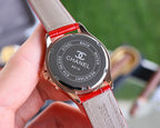 Chanel watch back with black dial text and red leather strap