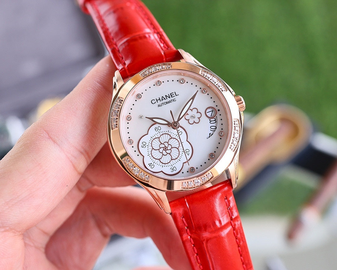 Chanel watch with red leather strap and rose-gold case, round white dial with floral motifs