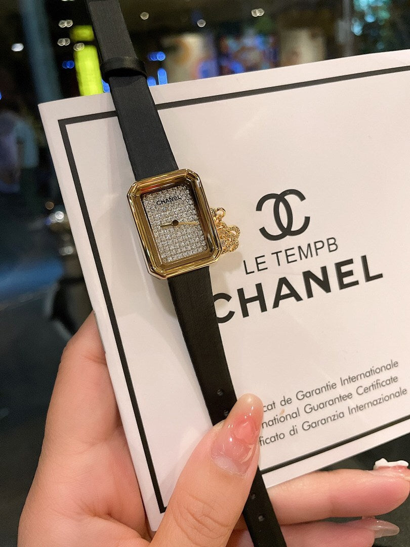 Chanel gold-tone square watch with black leather strap, textured dial and logo detail