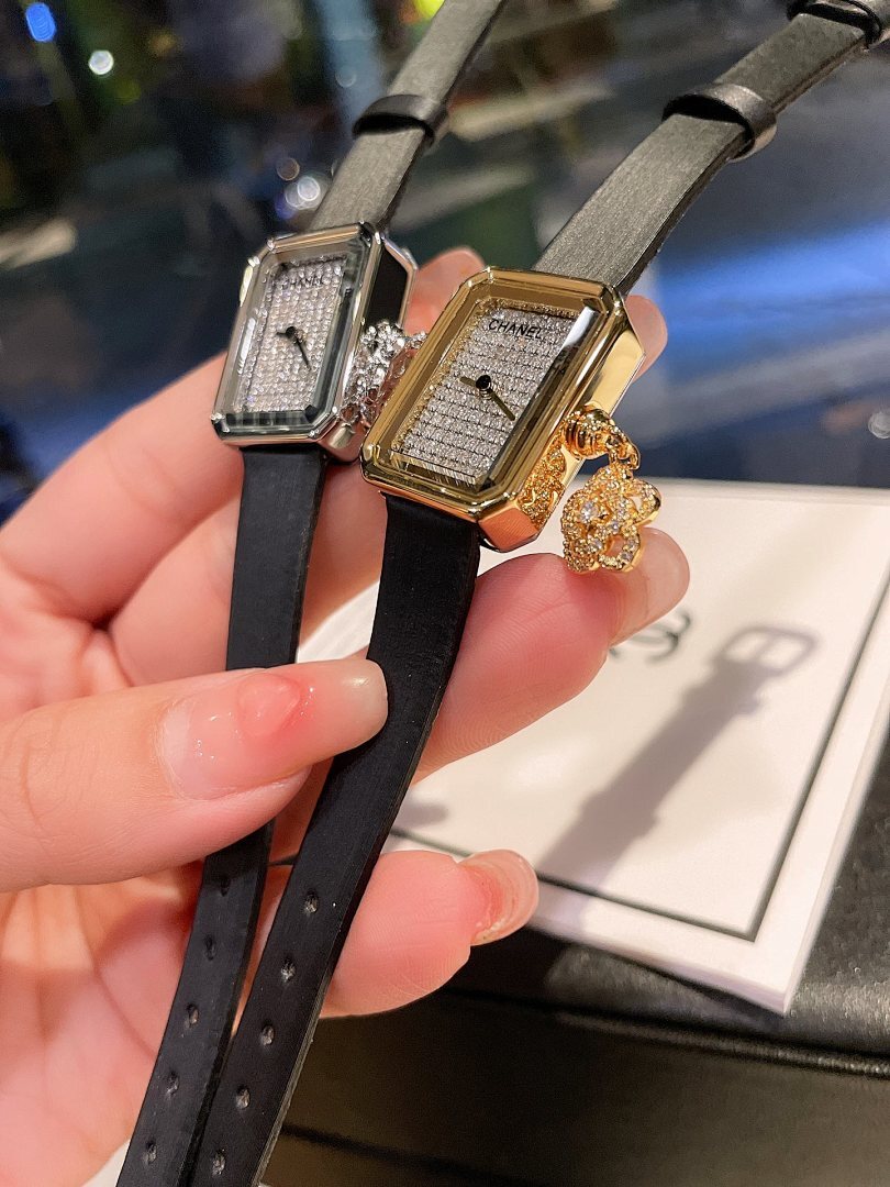 Chanel watch pair with black straps and square silver-tone and gold-tone cases