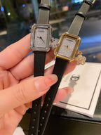 Chanel watch pair with black straps and square silver-tone and gold-tone cases
