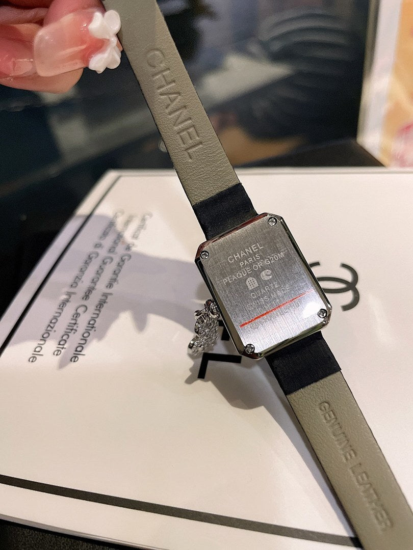 Chanel square watch with silver-tone textured dial and black leather strap