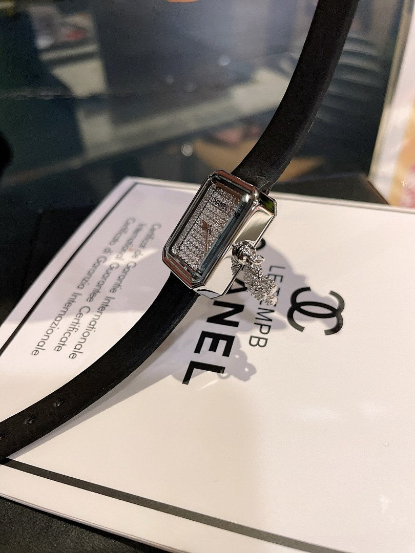 Chanel silver-tone square watch with black leather strap and textured dial