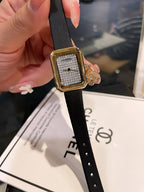 Chanel gold-tone square watch with black leather strap and textured dial