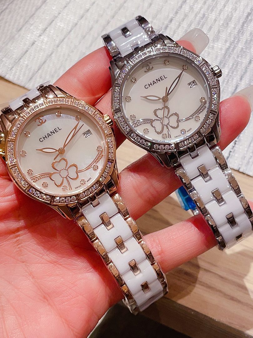Pair of Chanel wristwatches with jeweled bezels and metal link straps, white floral dials.