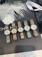 Set of Chanel watches on display, round dials with metal link bracelets