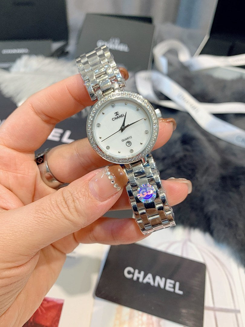 Chanel watch close-up held in hand, round silver dial and silver-tone metal bracelet
