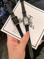 Chanel watch set with square silver cases, black leather straps, and white/black dials