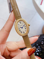 Oval wrist watch with brown leather strap, jeweled bezel, Roman numeral dial, blue hands