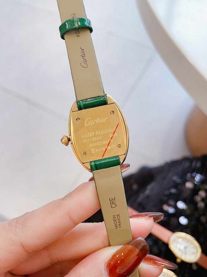 Oval wrist watch with green leather strap, jeweled bezel, Roman numeral dial, blue hands