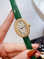 Oval wrist watch with green leather strap, jeweled bezel, Roman numeral dial, blue hands