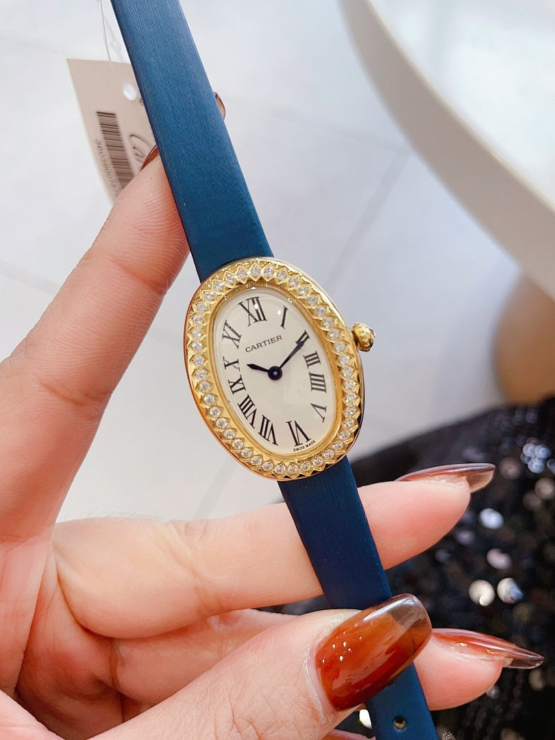 Oval wrist watch with blue leather strap, jeweled bezel, Roman numeral dial, blue hands