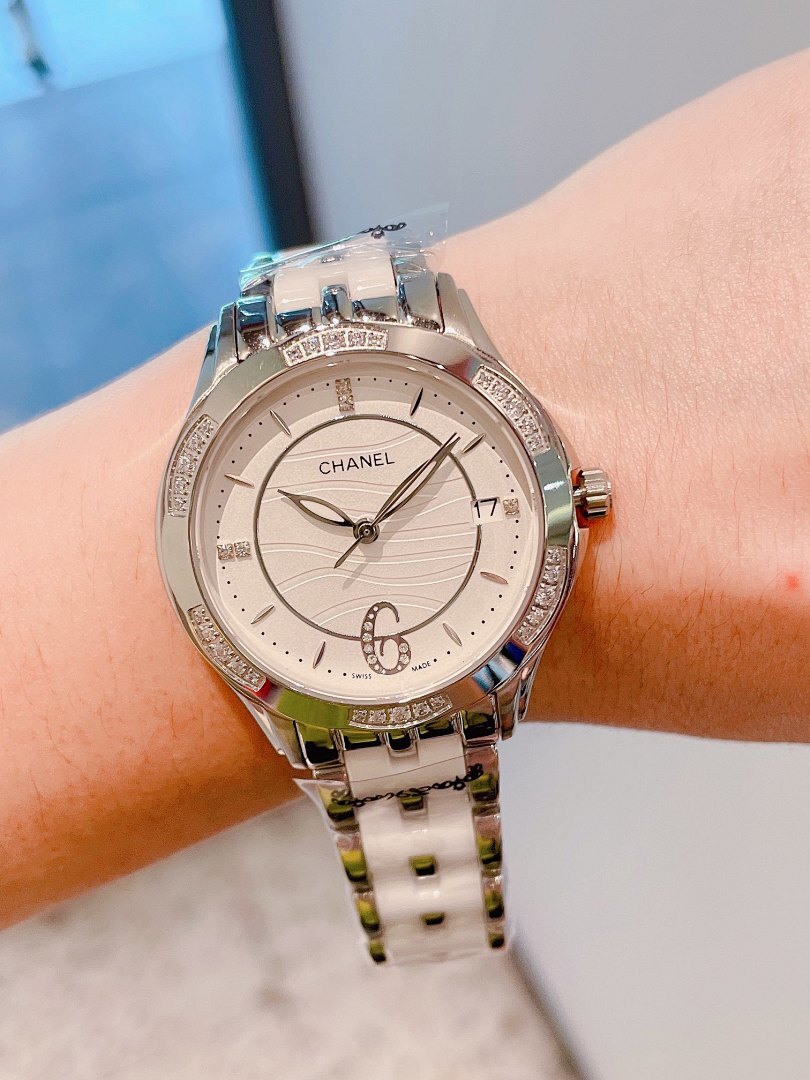 Chanel wristwatch with silver link bracelet, white dial, crystal bezel detail