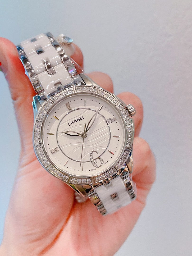 Chanel wristwatch with silver link bracelet, white dial, bezel set with crystals